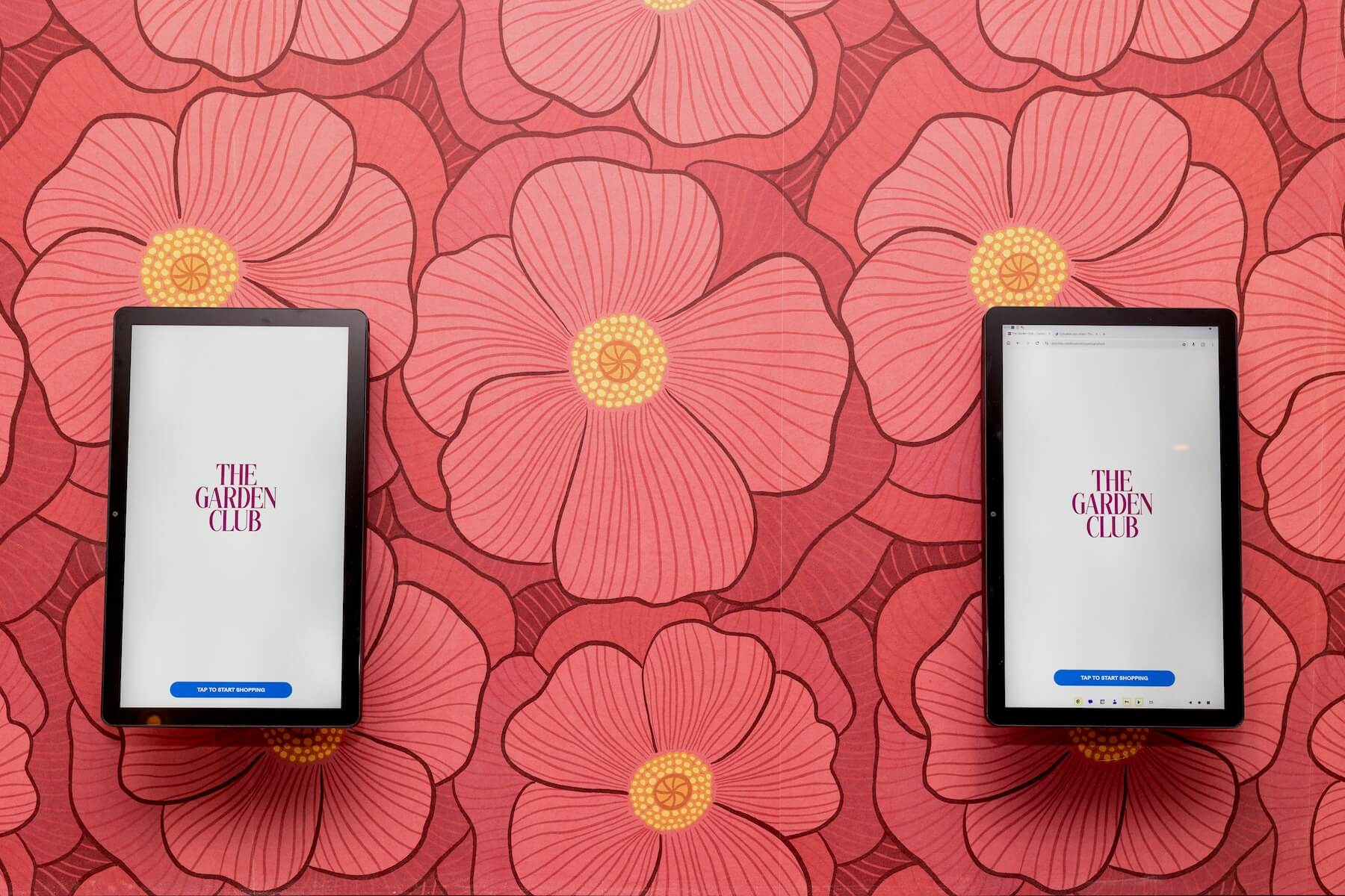 Tablet kiosks mounted on hand-illustrated poppy wallpaper